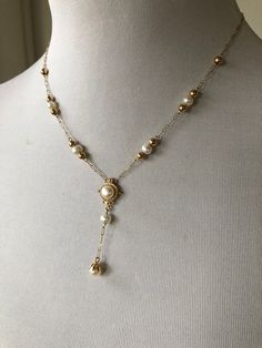 Solid 14k yellow gold and real pearl necklace. The back of the main pendant is stamped 14k. Very dainty ornate chain with pearl/gold ball stations. Light, feminine and pretty. Unknown origin. Could be antique or vintage. Possibly 1980s-90s with Victorian/Eastern European inspired design.  Total weight: 3.8 grams. Necklace: 16" (8" doubled), the dangle is approx. 1.5" to 1.75" Elegant Gold Dangle Backdrop Necklace, Elegant Gold Pearl Lariat Necklace, Heirloom Gold Jewelry With Pearl Drop, Elegant Gold Backdrop Necklace With Pearl Charm, Elegant Gold Lariat Necklace With Pearl Charm, Delicate Gold Pearl Lariat Necklace, Gold Lariat Pearl Necklace With Pendant, Gold Pearl Lariat Necklace With Delicate Chain, Victorian Gold Pearl Necklace With Pearl Drop