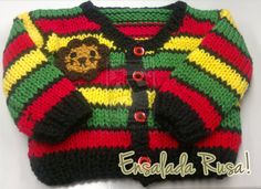 a knitted sweater with a monkey on the front and green, yellow, red, and black stripes