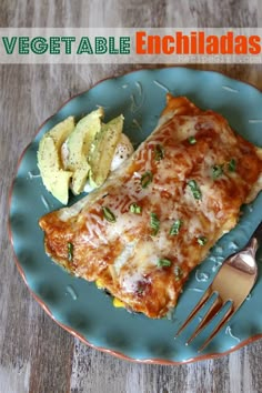 an enchilada on a blue plate with a fork and some guacamole