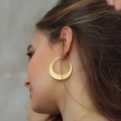 W H A T ∙ M A K E S ∙ T H I S ∙ S P E C I A L A crescent-shaped take on the classic hoop earring that draws influences from both tribal and 1970s jewellery. The half moon shapes are cut from on-trend raw silver giving them their slightly matte gold finish. Try pairing these crescent moon earrings with jeans and a loose t-shirt for a casual festival feel. Simple, delicate and versatile... you'll want in your collection. - we use only the finest quality materials - all components are 100% sterling 1970s Jewelry, Hoop Earrings Large, Gold Crescent Moon, Casual Festival, Crescent Moon Earrings, Hoop Earrings Gold, Gold Moon, Moon Shapes, Silver Prices