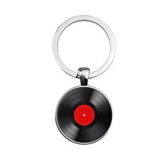 a black and red keychain with a record on it's front end