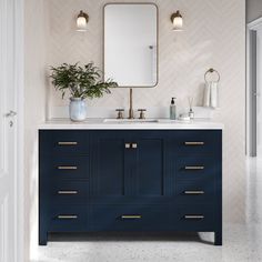 a bathroom with a blue vanity and mirror