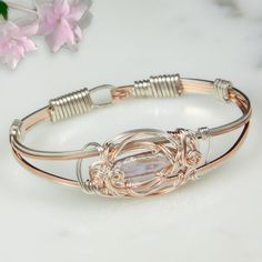 “This design is Inspired by the gentle curls of swirling water, I designed sterling silver and rose gold-filled wire to complement the lovely soft pink pearl. Over 8 feet of wire is used to create the bracelet." -Laura Glen Freshwater Pearl Gently squeeze the bracelet sides to open and close Handmade with subtle design variations Each pearl is unique, with subtle variations Twisted Jewelry, Twist Jewelry, Art Wire, Freshwater Pearl Bracelet, Bracelet Diy, Extended Family, Wire Rings, Pink Pearl, Wire Art