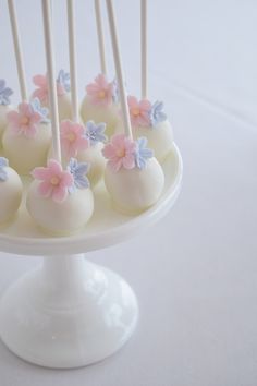 cake pops decorated with flowers and white frosting