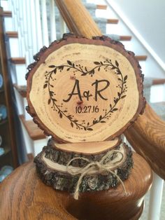 a wooden plaque that says ar on it sitting on top of a stair case next to some stairs