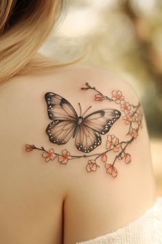 a woman's shoulder with a butterfly tattoo on the back of her left shoulder