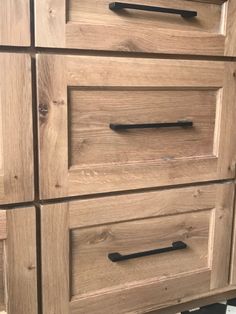 a wooden dresser with black handles and drawers