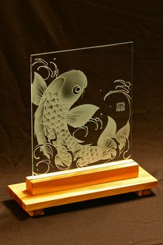 a glass block with an image of a koi fish on it's side