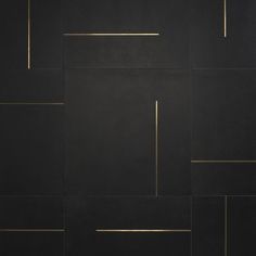 a black wall with gold lines on it