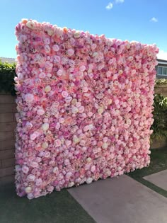 a large pink flowered wall in front of a house