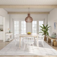 a dining room with white chairs and a table surrounded by plants in the middle of the room