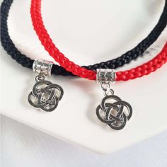 "This lucky knot Asian/Chinese style choker necklace is woven in a Kumihimo style flat braid band with 8 strands of 1mm thick satin thread in red or black color(custom colors available accented with a silver lucky knot charm and matching adjustable chain/lobster clasp.  The size range is 15\" to 17\".  For customized sizes, or custom colors please send me a message. Please have a look at my other EIGHT STRANDS Collections!  All designs are created by weaving a quantity of EIGHT pieces of string -  8, 18, 28...etc.  The number EIGHT is considered very LUCKY in Chinese because it is similar in sound to the word for FORTUNE and SUCCESS.  So I hope I can send a little luck and positive energy with each piece that I create! My designs are Asian-inspired, based on my experiences living in Hong K Red Braided Jewelry As A Gift, Red Braided Jewelry For Gifts, Red Braided Jewelry Perfect As A Gift, Braided Nylon Cord Jewelry Gift, Braided Nylon Cord Jewelry As Gift, Braided Nylon Cord Jewelry For Gifts, Silver Braided Jewelry For Friendship, Year Necklace, Red Or Black