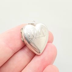 DESCRIPTION: A beautiful antique solid heart locket, with a engraved pattern on the face. The locket is stamped "SILVER" and has it's original picture retaining shims for both sides (made from base metal). It weighs approx. 5.56g and the size dimensions are in the later photos. Mountains of unique antique and vintage pieces in our shop!  **FREE worldwide shipping on all items. Fill your boots **Plenty of experience. Everything guaranteed and authentic **Returns accepted Check out our Instagram a Victorian Heart Locket Necklace For Anniversary, Hallmarked Heart Pendant Locket Necklace For Keepsake, Victorian Heart Pendant Locket Necklace For Anniversary, Antique Heart Charm Locket Necklace For Anniversary, Vintage Antique Silver Heart Jewelry, Antique Heart Pendant Locket Necklace For Wedding, Vintage Double Heart Locket Necklace For Valentine's Day, Victorian Heart-shaped Engraved Necklace, Engraved Heart Locket Necklace For Wedding