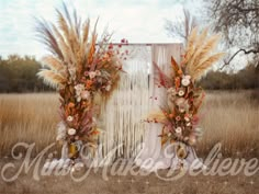 an outdoor wedding ceremony setup with tall grass and dried flowers on the front door frame