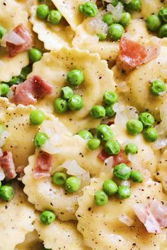 a close up view of pasta with peas and ham