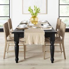 a dining room table set with place settings