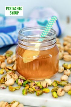 pistachio syrup in a glass jar with a green straw