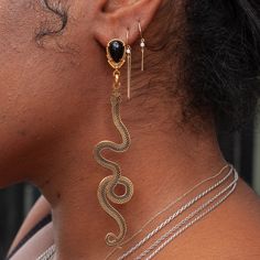 Slither up, slither down. A pair of golden snakes dangle asymmetrically in a pair of statement earrings in gold plating & enamel. Handmade by La Libertad in their Colombia Studio. Gold Snake Earrings For Party, Golden Snake, Welding Shop, Stacking Bands, Earrings In Gold, Enamel Earrings, Snakes, Piercing Jewelry, Earring Necklace