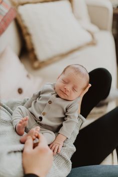 a woman holding a baby in her lap