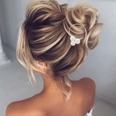 a woman with blonde hair in a low bun