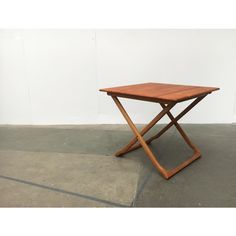 a wooden table sitting on top of a cement floor