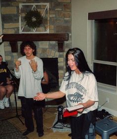 a group of people standing around in a living room