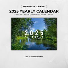 a calendar with trees and water in the background