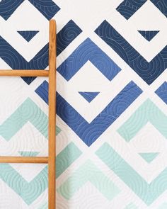 a ladder leaning against a blue and white quilt