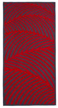 a red and black rug with an abstract design