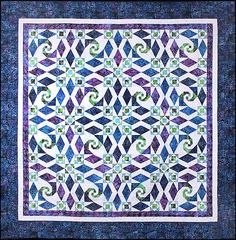 a blue and white quilt with swirls on it