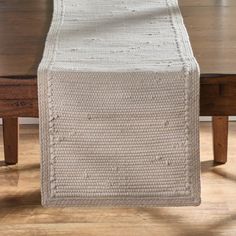 the table runner is knitted in white yarn