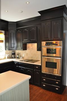 a kitchen with black cabinets and white counter tops is shown on the instagram page