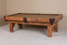 a pool table made out of wooden planks with two black cups on each end