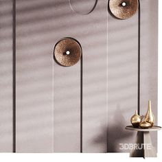 three gold vases sitting on top of a table next to a metal wall mounted clock