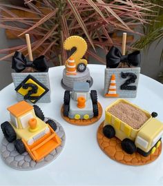 there are three cakes made to look like construction vehicles