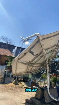 a large white boat sitting on top of a pile of junk next to a building