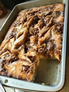 there is a cake in the pan with icing on it, ready to be eaten