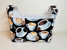 a black and white bag with coffee cups on it