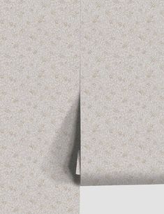 the wall paper is white and has a pattern on it