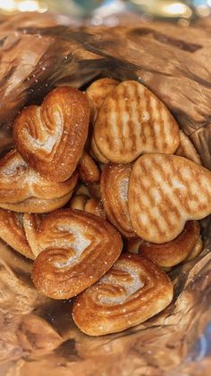 a bowl filled with cookies on top of a wooden table