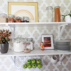 a white shelf filled with plates and bowls