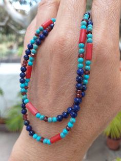 A Boho style Necklace made of multi gemstone.  We have Lapis Lazuli, Blue Turquoise, Matte Finished Red Coral(Sea Bamboo) and Garnet in this necklace. Width of the necklace is 4mm. (0.14")    Clasp is a 925 Sterling Lobster Clasp. Length is 17.5" or 44.5cm. Weight is 10 grams.  Stringing is on Soft Flex - Soft Touch 49 Strands beading wire for máximum strength and flexibility. Photos are close-up, so check actual size carefully. Color varies with monitor. Shipping is from the Canary Islands, Spain. (Please see Shipping & Policy) A Reminder:  Any of our listings on Solitary Mountain can be combined with any of our listings on Peridot Mountain. https://www.etsy.com/shop/PeridotMountain?ref=hdr_shop_menu Simply request Custom Listing. Yesterday climbed to the top of the volcano Guardilama, fr Artisan Multi-stone Turquoise Necklace, Artisan Blue Multi-stone Turquoise Necklace, Artisan Blue Turquoise Multi-stone Necklace, Southwestern Blue Gemstone Necklace, Blue Double Strand Gemstone Beads Jewelry, Blue Double Strand Natural Stones Jewelry, Blue Round Beads Fusion Jewelry, Southwestern Blue Beaded Necklaces For Gift, Southwestern Style Blue Beaded Necklace For Gift