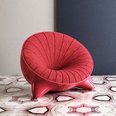 a red chair sitting on top of a table