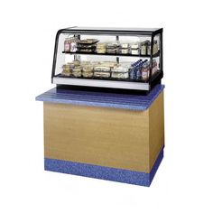 a deli display case with food in it on top of a blue countertop