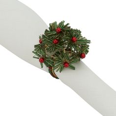 a white napkin with a green and red christmas tree on it's side, in front of a white background