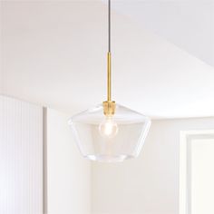 a light fixture hanging from the ceiling in a room with white walls and flooring