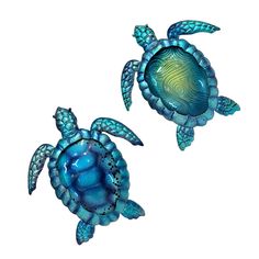 two blue sea turtle figurines sitting next to each other on a white background