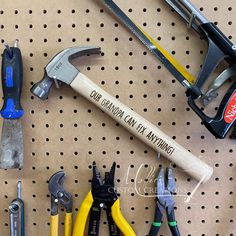 there are many different tools on the pegboard