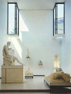 the room is filled with statues and sculptures