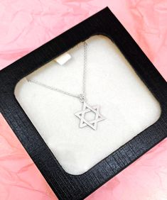 Beautifully crafted Star Of David Necklace. Add this symbolic piece to your collection or get it a as gift. This .75" Star of David pendant delicately hangs from a 16" inch chain with a convenient 2" extension and lobster claw closure. Made of premium quality, outstanding craftsmanship. Available in Gold and Silver. Take advantage of our Bulk discount! 6 Necklaces - 30% Off ($14 each) 12 Necklaces - 50% Off ($10 each) Spiritual Sterling Silver Necklace Ideal For Gifting, Spiritual Sterling Silver Necklace, Star Charm Jewelry As Gift, Adjustable Silver Charm Necklace Gift, Star Charm Pendant Jewelry Gift, Spiritual Sterling Silver Necklace Gift, Minimalist Star Charm Jewelry Gift, Handmade Star Charm Necklace As Gift, Star Of David Necklace For Gift